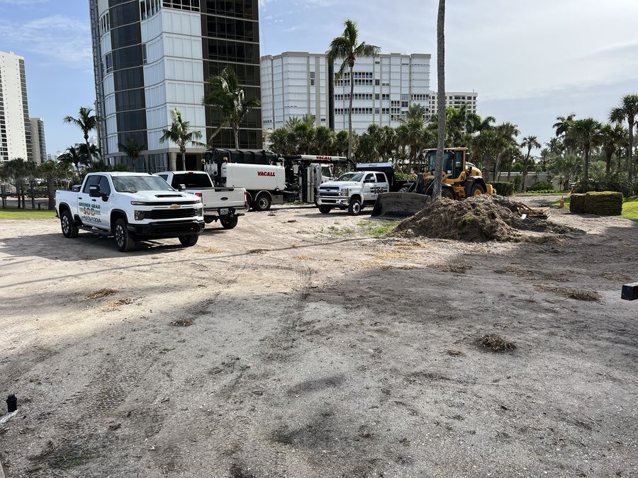 Greener Grass trucks and a wheel loader on a condo job site