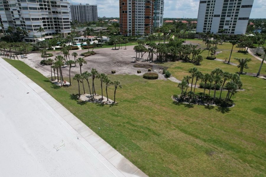 Aerial of condo grounds partly sodded, the rest graded to sand