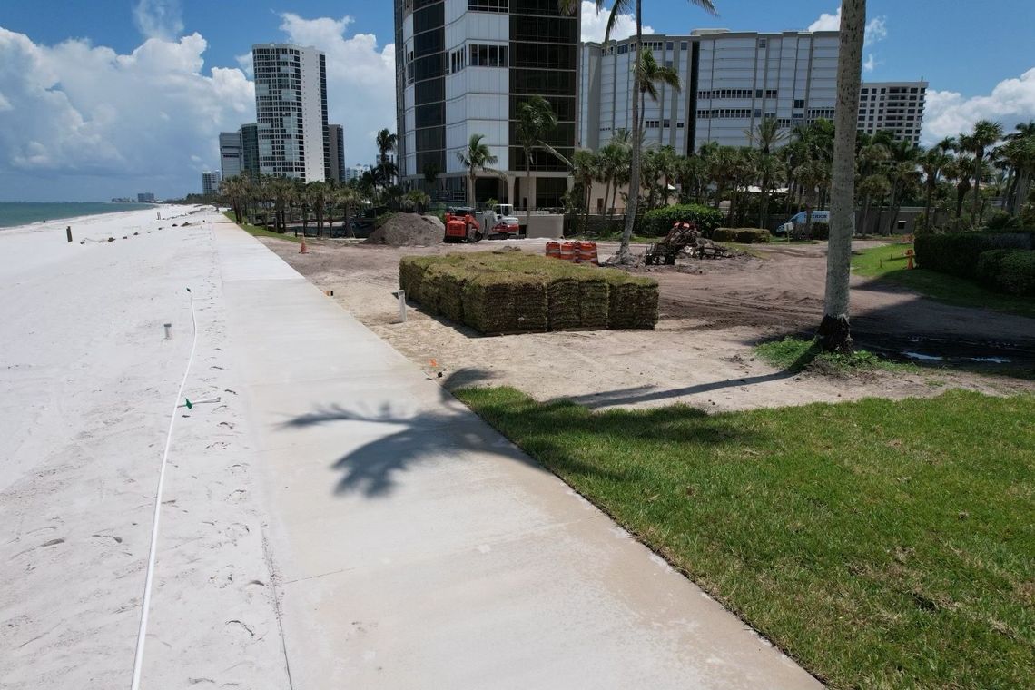Aerial of sod pallets staged beside a beachfront walkway
