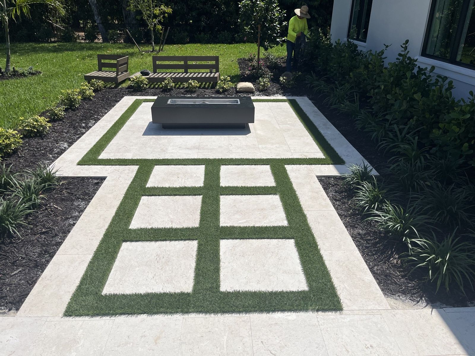 Same patio with artificial turf inlaid between the slabs