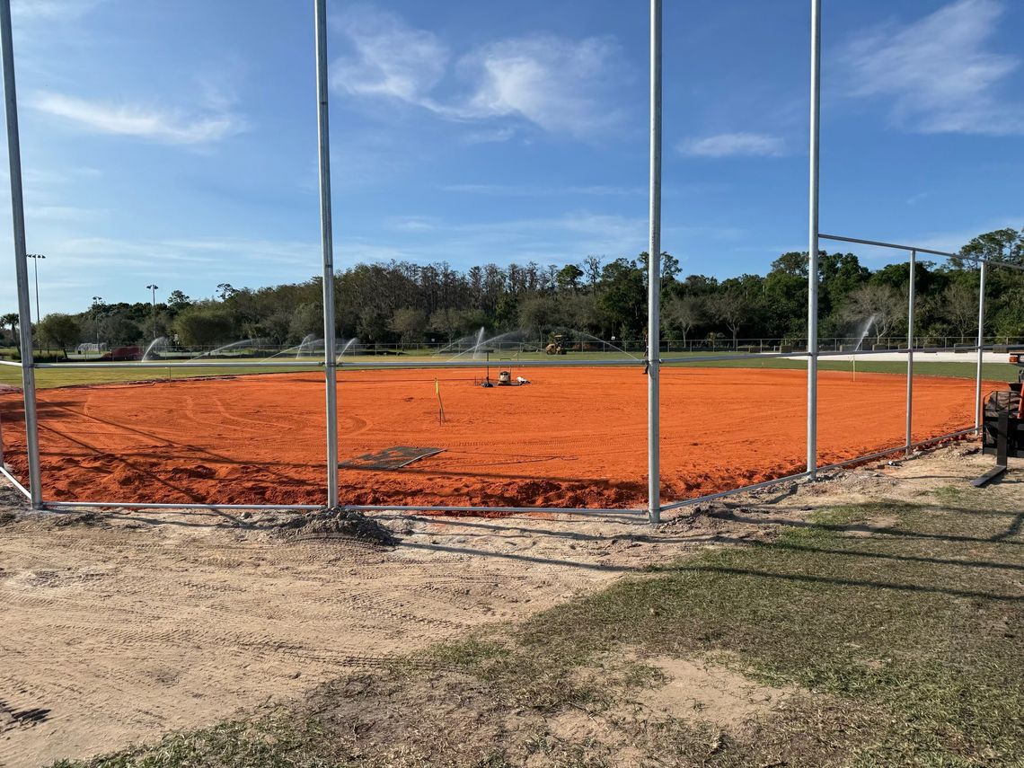 Ballfield infield with fresh clay and irrigation running