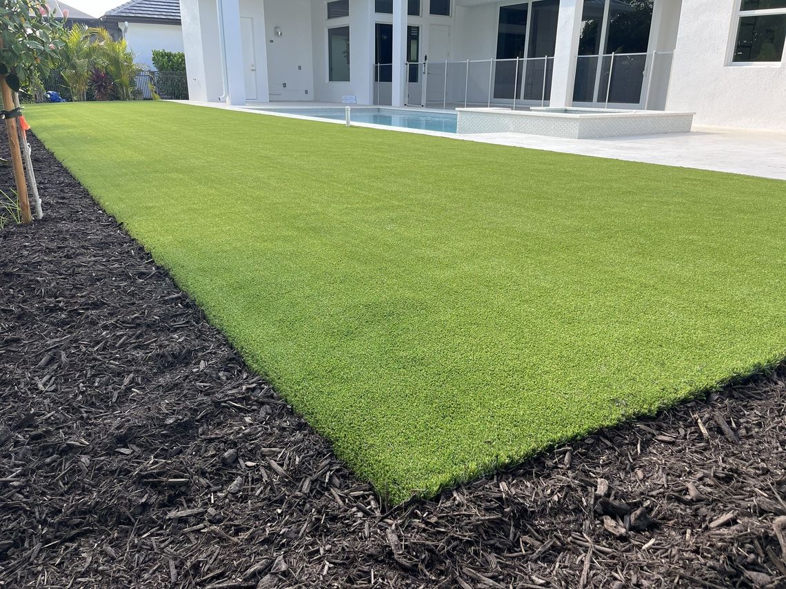 Finished artificial turf lawn beside a pool