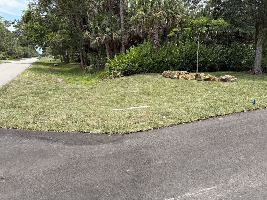 Finished sod on a residential corner lot with swale